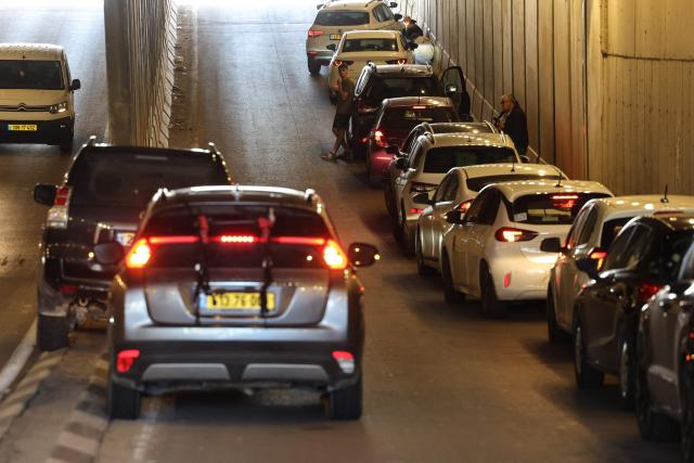 People take shelter inside a tunnel near Abu Ghosh as missile-warning sirens sound on March 28, 2026. The Middle East was sparked by joint US-Israeli strikes on Iran that triggered a wave of retaliatory missile and drone attacks against Israel and several other countries in the region. (Photo by Ahmad GHARABLI / AFP) / 