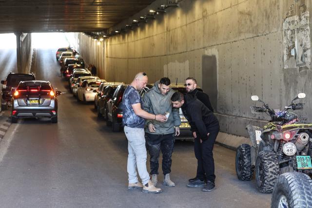 People take shelter inside a tunnel near Abu Ghosh as missile-warning sirens sound on March 28, 2026. The Middle East was sparked by joint US-Israeli strikes on Iran that triggered a wave of retaliatory missile and drone attacks against Israel and several other countries in the region. (Photo by Ahmad GHARABLI / AFP) / 