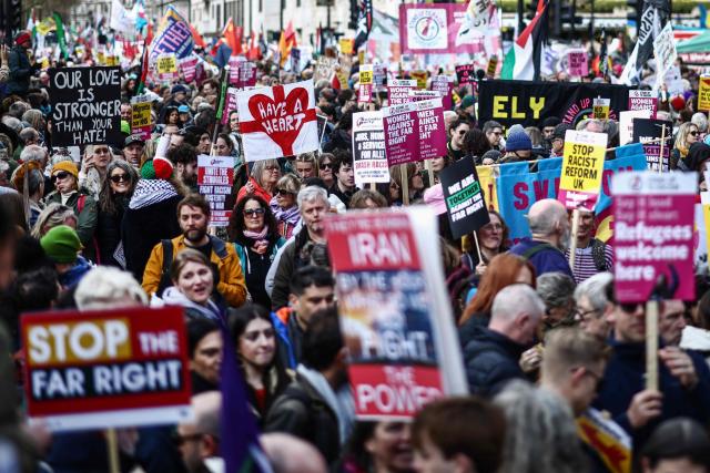 Protesters holding placards and waving flags take part in a march against the far right, organised by the Together Alliance, in central London on March 28, 2026. (Photo by Henry NICHOLLS / AFP)