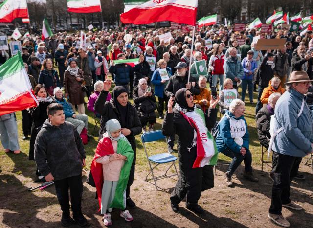 Protestors some carrying Iranian national flags shout slogans as they take part in a demonstration against military attacks by the United States and Israel on Iran entitled 'Stop the war against Iran!'  on the Malieveld in The Hague on March 28, 2026. (Photo by Lina Selg / ANP / AFP) / Netherlands OUT