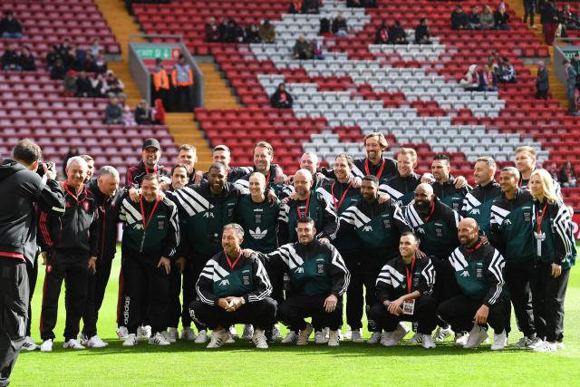 Liverpool Legends' team pose for a picture ahead of the Legends football match between Liverpool Legends and Dortmund Legends at Anfield in Liverpool, north-west England on March 28, 2026. (Photo by PETER POWELL / AFP)
