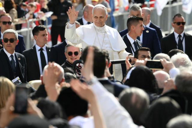 Pope Leo XIV waves as he arrives to lead a Holy Mass at the Louis II Stadium in Monaco, on March 28, 2026. Pope Leo XIV denounced the widening gap between the haves and have-nots as he visited Monaco, a millionaires' playground that is the surprise pick for the first western European trip of his papacy. (Photo by Marco BERTORELLO / AFP)
