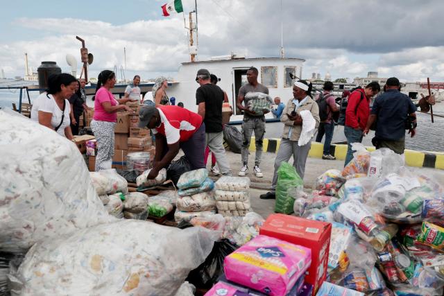(FILES) Activists of the Nuestra America Convoy and Cuban officials unload humanitarian aid from the vessel Maguro -- symbolically renamed "Granma 2.0" as a tribute to the yacht used by Fidel Castro's guerrilla fighters to launch their revolution in 1956 -- at Havana port on March 24, 2026. Two sailboats that disappeared while taking humanitarian aid from Mexico to Cuba have been located by the Mexican Navy and its crew is safe, organizers and Mexican authorities said on March 28, 2026. (Photo by JORGE LUIS BANOS / POOL / AFP)