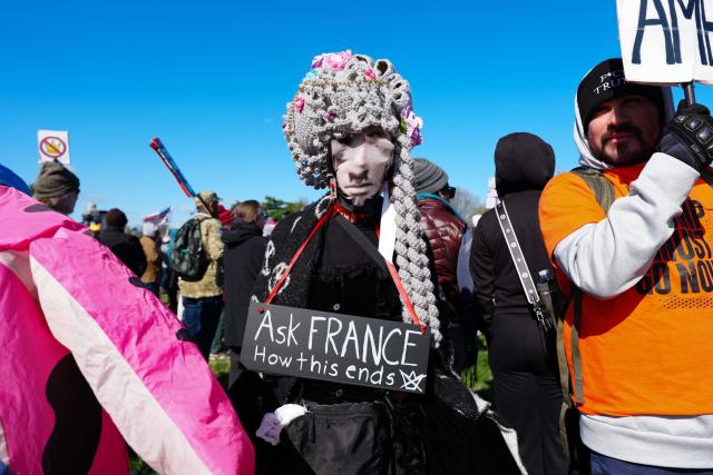 Demonstrators prepare to walk across the Memorial Bridge from Arlington, Virginia into Washington, DC, during the "No Kings" national day of protest on March 28, 2026. Nationwide protests against US President Donald Trump are expected Saturday as millions of people vent fury over what they see as his authoritarian bent and other forms of cruel, law-trampling governance. It is the third time in less than a year that Americans will take to the streets as part of a grassroots movement called "No Kings," the most vocal and visual conduit for opposition to Trump since he began his second term in January 2025. (Photo by Aaron Schwartz / AFP)