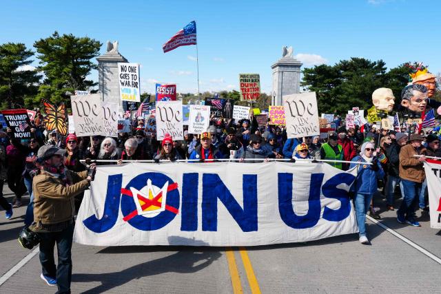 Demonstrators walk across the Memorial Bridge from Arlington, Virginia into Washington, DC, during the "No Kings" national day of protest on March 28, 2026. Nationwide protests against US President Donald Trump are expected Saturday as millions of people vent fury over what they see as his authoritarian bent and other forms of cruel, law-trampling governance. It is the third time in less than a year that Americans will take to the streets as part of a grassroots movement called "No Kings," the most vocal and visual conduit for opposition to Trump since he began his second term in January 2025. (Photo by Aaron Schwartz / AFP)