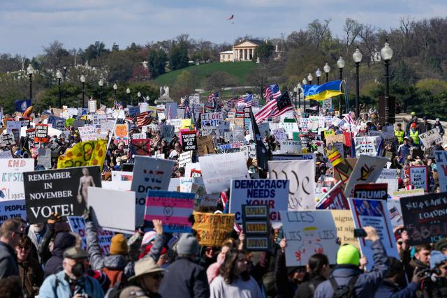 Demonstrators walk across the Memorial Bridge from Arlington, Virginia into Washington, DC, during the "No Kings" national day of protest on March 28, 2026. Nationwide protests against US President Donald Trump are expected Saturday as millions of people vent fury over what they see as his authoritarian bent and other forms of cruel, law-trampling governance. It is the third time in less than a year that Americans will take to the streets as part of a grassroots movement called "No Kings," the most vocal and visual conduit for opposition to Trump since he began his second term in January 2025. (Photo by Ken Cedeno / AFP)