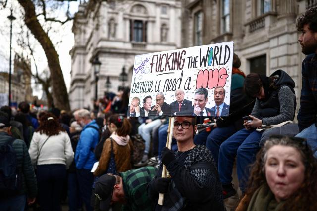 EDITORS NOTE: Graphic content / Protesters holding placards gather ahead of speeches after a march against the far right, organised by the Together Alliance, in central London on March 28, 2026. (Photo by Henry NICHOLLS / AFP)