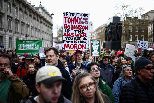Protesters holding placards gather ahead of speeches after a march against the far right, organised by the Together Alliance, in central London on March 28, 2026. (Photo by Henry NICHOLLS / AFP)