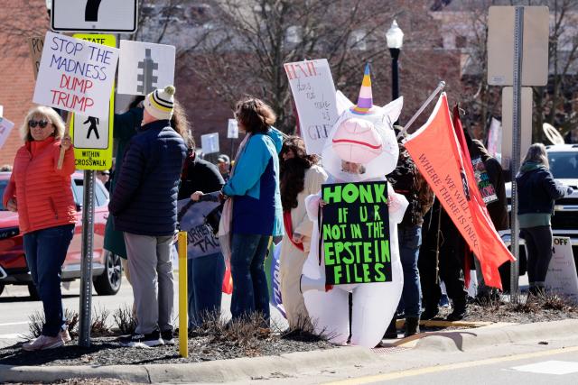 Demonstrators take part in the "No Kings" national day of protest in Howell, Michigan, on March 28, 2026. Nationwide protests against US President Donald Trump are expected Saturday as millions of people vent fury over what they see as his authoritarian bent and other forms of cruel, law-trampling governance. It is the third time in less than a year that Americans will take to the streets as part of a grassroots movement called "No Kings," the most vocal and visual conduit for opposition to Trump since he began his second term in January 2025. (Photo by JEFF KOWALSKY / AFP)