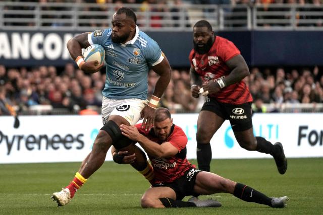 Perpignan’s Fijian lock Peceli Yato (L) is tackled as he runs with the ball during the French Top 14 rugby union match between USA Perpignan and Rugby Club Toulonnais (Toulon) at the Aime-Giral stadium in Perpignan, south-western France on March 28, 2026. (Photo by Idriss Bigou-Gilles / AFP)