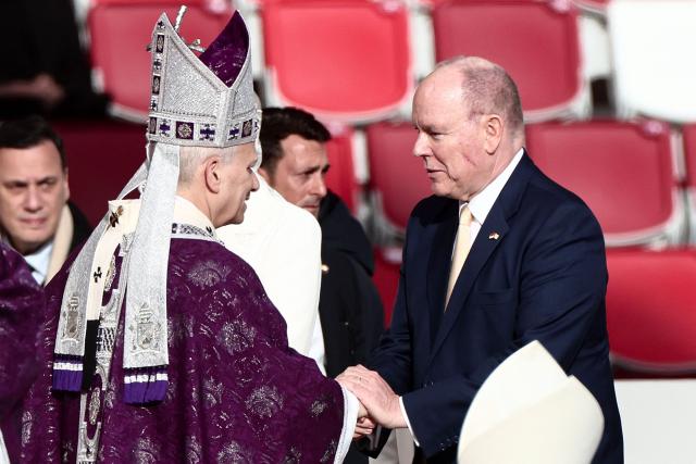 Pope Leo XIV greets Prince's Albert II of Monaco during a Holy Mass at the Louis II Stadium in Monaco, on March 28, 2026. Pope Leo XIV denounced the widening gap between the haves and have-nots as he visited Monaco, a millionaires' playground that is the surprise pick for the first western European trip of his papacy. (Photo by Thibaud MORITZ / AFP)