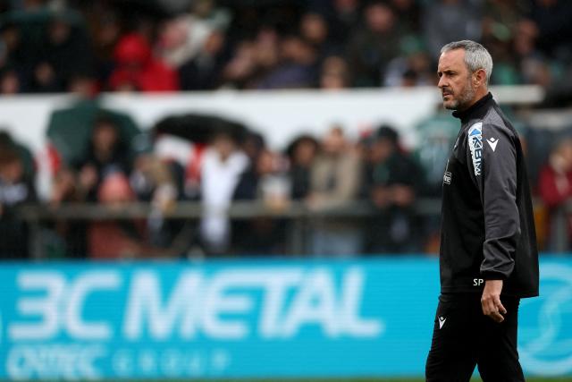 Pau's French head coach Sebastien Piqueronies looks on during a warm up ahead of the French Top14 rugby union match between Section Paloise Bearn Pyrenees (Pau) and Racing92 at Stade du Hameau in Pau, south-western France on March 28, 2026. (Photo by ROMAIN PERROCHEAU / AFP)