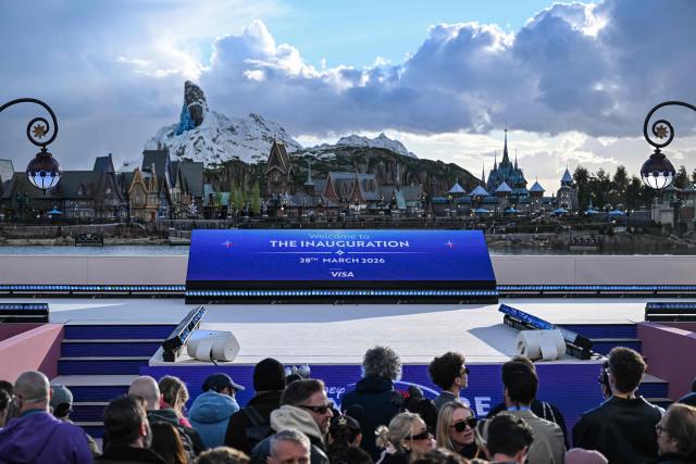 Guests attend the inauguration of the new Disney Park extension Disney Adventure World theme 'World of Frozen' at Disneyland Paris in Marne-la-Vallee, east of Paris, on March 28, 2026. The Disney adventure World will officially open to the public on March 29, 2026. (Photo by Blanca CRUZ / AFP)