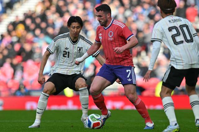 Japan's defender Hiroki Ito (L) vies with Scotland's midfielder #07 John McGinn (C) during the friendly International football match between Scotland and Japan at Hampden Park, in Glasgow, on March 28, 2026. (Photo by ANDY BUCHANAN / AFP)