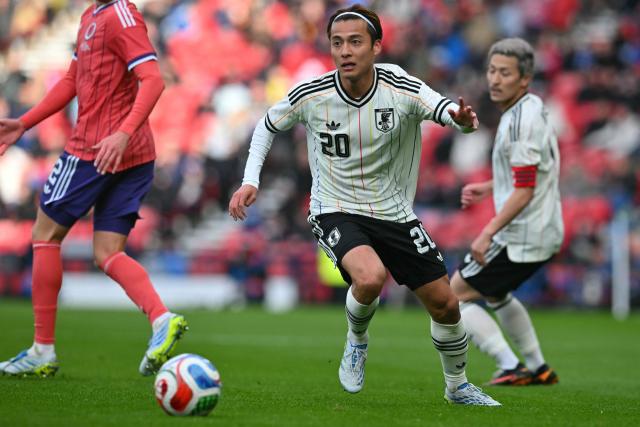 Japan's midfielder Kodai Sano runs with the ball during the friendly International football match between Scotland and Japan at Hampden Park, in Glasgow, on March 28, 2026. (Photo by ANDY BUCHANAN / AFP)