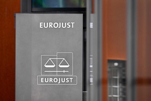 This picture taken on March 28, 2026 shows the logo of EU Agency for Criminal Justice Cooperation (Eurojust) at the Eurojust headquarters in The Hague. (Photo by JOHN THYS / AFP)