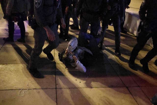 Israeli police arrest a protester from the weekly anti-war demonstration at HaBima Square in Tel Aviv on March 28, 2026 amid safety concerns over possible projectile attacks. The US and Israel launched strikes against Iran on February 28, sparking swift retaliation by the Islamic republic which responded with missile attacks across the region. (Photo by Ilia YEFIMOVICH / AFP)