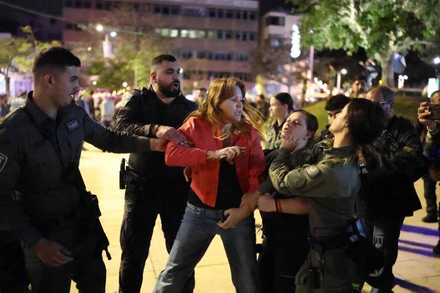 Israeli police arrest a protester from the weekly anti-war demonstration at HaBima Square in Tel Aviv on March 28, 2026 amid safety concerns over possible projectile attacks. The US and Israel launched strikes against Iran on February 28, sparking swift retaliation by the Islamic republic which responded with missile attacks across the region. (Photo by Ilia YEFIMOVICH / AFP)