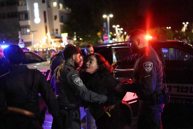 Israeli police arrest a protester from the weekly anti-war demonstration at HaBima Square in Tel Aviv on March 28, 2026 amid safety concerns over possible projectile attacks. The US and Israel launched strikes against Iran on February 28, sparking swift retaliation by the Islamic republic which responded with missile attacks across the region. (Photo by Ilia YEFIMOVICH / AFP)