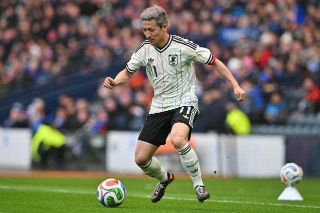 Japan's forward Daizen Maeda runs with the ball during the friendly International football match between Scotland and Japan at Hampden Park, in Glasgow, on March 28, 2026. (Photo by ANDY BUCHANAN / AFP)