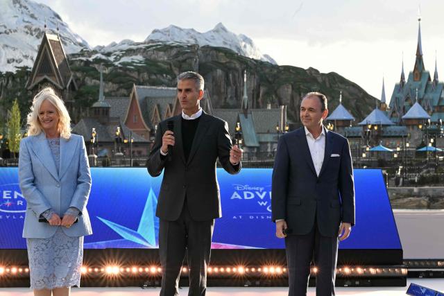 Disney CEO Josh D'Amaro (C) speaks as Disneyland Paris President Natacha Rafalski (L) and Chairman Disney Experiences Thomas Mazloum (R) look on during the inauguration of the expanded 'Disney Adventure World' at Marne-la-Vallee, east of Paris on March 28, 2026. (Photo by Blanca CRUZ / AFP)