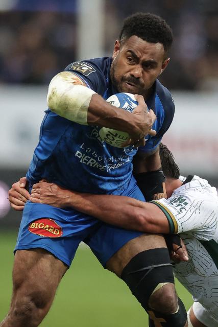 Castres' Fijian centre Adrea Cocagi is tackled during the French Top 14 rugby union match between Castres Olympique and US Montauban at Stade Pierre Fabre in Castres, southern France on March 28, 2026. (Photo by Valentine CHAPUIS / AFP)