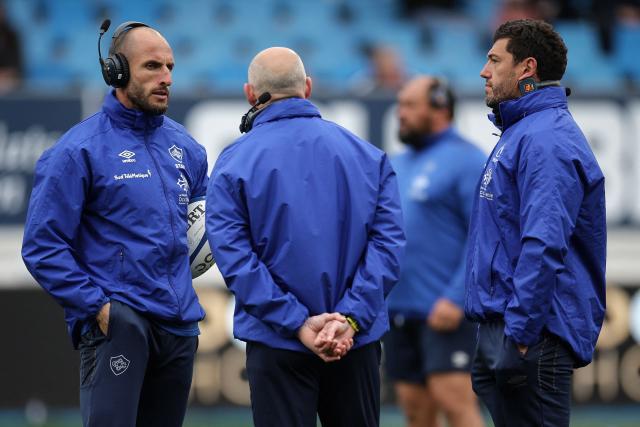 Castres' French head coach Xavier Sadourny (back C) speaks with Castre's French coach Julien Dumora (L) prior to the French Top 14 rugby union match between Castres Olympique and US Montauban at Stade Pierre Fabre in Castres, southern France on March 28, 2026. (Photo by Valentine CHAPUIS / AFP)