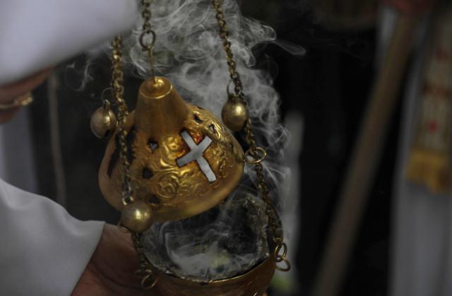 Incense burns during a Palm Sunday service at the Queen of Peace  Church in Arbil, the capital of the autonomous Kurdish region of northern Iraq, on March 28, 2026. (Photo by Safin HAMID / AFP)