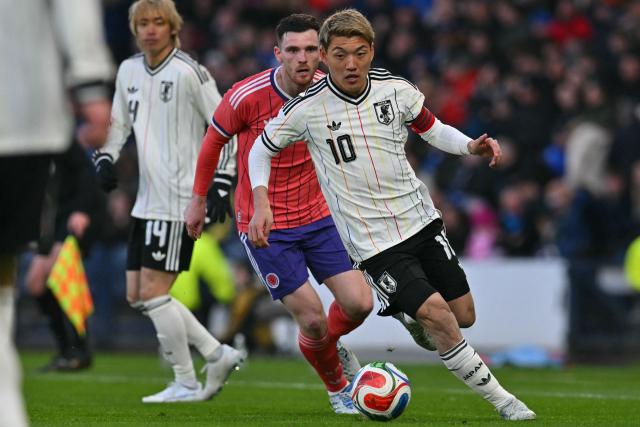 Japan's midfielder Ritsu Doan runs with the ball during the friendly International football match between Scotland and Japan at Hampden Park, in Glasgow, on March 28, 2026. (Photo by ANDY BUCHANAN / AFP)