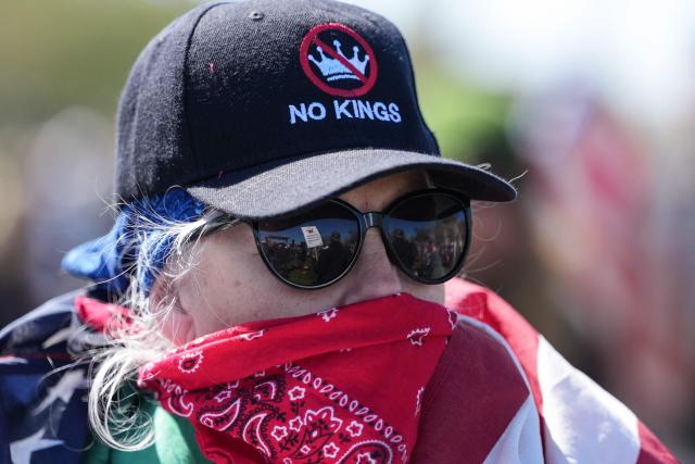 A woman wears a hat reading "No Kings" as she participates in the "No Kings" national day of protest on the National Mall in Washington, DC, on March 28, 2026. Nationwide protests against US President Donald Trump are expected Saturday as millions of people vent fury over what they see as his authoritarian bent and other forms of cruel, law-trampling governance. It is the third time in less than a year that Americans will take to the streets as part of a grassroots movement called "No Kings," the most vocal and visual conduit for opposition to Trump since he began his second term in January 2025. (Photo by Ken Cedeno / AFP)
