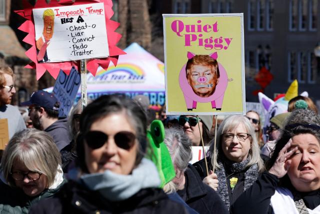 Demonstrators take part in the "No Kings" national day of protest outside the Michigan State Capitol building in Lansing, Michigan, on March 28, 2026. Nationwide protests against US President Donald Trump are expected Saturday as millions of people vent fury over what they see as his authoritarian bent and other forms of cruel, law-trampling governance. It is the third time in less than a year that Americans will take to the streets as part of a grassroots movement called "No Kings," the most vocal and visual conduit for opposition to Trump since he began his second term in January 2025. (Photo by JEFF KOWALSKY / AFP)