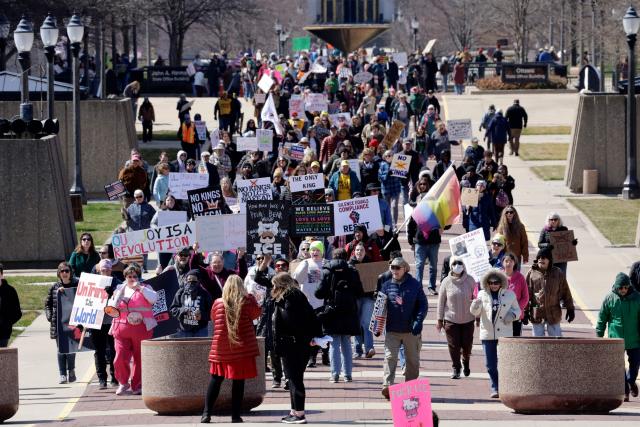Demonstrators take part in the "No Kings" national day of protest outside the Michigan State Capitol building in Lansing, Michigan, on March 28, 2026. Nationwide protests against US President Donald Trump are expected Saturday as millions of people vent fury over what they see as his authoritarian bent and other forms of cruel, law-trampling governance. It is the third time in less than a year that Americans will take to the streets as part of a grassroots movement called "No Kings," the most vocal and visual conduit for opposition to Trump since he began his second term in January 2025. (Photo by JEFF KOWALSKY / AFP)