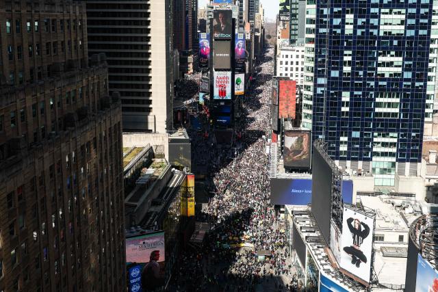 Protesters descend on Times Square during the "No Kings" national day of protest in New York on March 28, 2026. Nationwide protests against US President Donald Trump are expected Saturday as millions of people vent fury over what they see as his authoritarian bent and other forms of cruel, law-trampling governance. It is the third time in less than a year that Americans will take to the streets as part of a grassroots movement called "No Kings," the most vocal and visual conduit for opposition to Trump since he began his second term in January 2025. (Photo by CHARLY TRIBALLEAU / AFP)