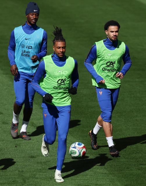 (from L) France's midfielder #06 Eduardo Camavinga, France's forward #11 Michael Olise, France's midfielder #18 Warren Zaire Emery attend a training session at the  Northwest Stadium in Landover, Maryland, on March 28, 2026 on the eve of the friendly football match between Colombia and France. France will play against Colombia in an international friendly football match on March 29, 2026, in preparation for the upcoming FIFA World Cup. (Photo by FRANCK FIFE / AFP)