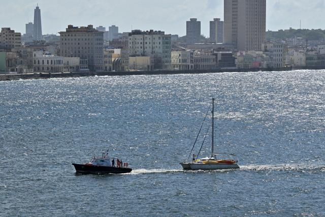 This view shows one of the two sailboats (R) carrying humanitarian aid that had previously gone missing arriving at the port of Havana on March 28, 2026. Two sailboats carrying humanitarian aid to crisis-hit Cuba reached Havana on Saturday after a long journey from Mexico during which they went missing and triggered a search-and-rescue mission, (Photo by Adalberto ROQUE / AFP)