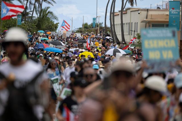 Demonstrators march during the "No Kings" national day of protest that included opposition to the proposed Esencia coastal development project in San Juan, Puerto Rico, on March 28, 2026. Nationwide protests against US President Donald Trump are expected Saturday as millions of people vent fury over what they see as his authoritarian bent and other forms of cruel, law-trampling governance. It is the third time in less than a year that Americans will take to the streets as part of a grassroots movement called "No Kings," the most vocal and visual conduit for opposition to Trump since he began his second term in January 2025. (Photo by Ricardo ARDUENGO / AFP)