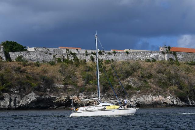 This view shows one of the two sailboats carrying humanitarian aid that had previously gone missing arriving at the port of Havana on March 28, 2026. Two sailboats carrying humanitarian aid to crisis-hit Cuba reached Havana on Saturday after a long journey from Mexico during which they went missing and triggered a search-and-rescue mission, (Photo by Yamil LAGE / AFP)