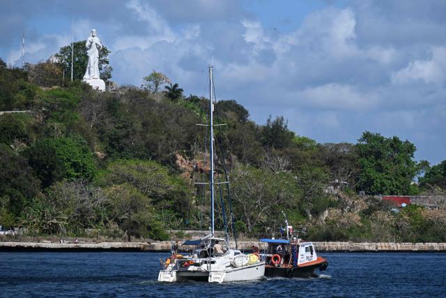 This view shows one of the two sailboats (L) carrying humanitarian aid that had previously gone missing arriving at the port of Havana on March 28, 2026. Two sailboats carrying humanitarian aid to crisis-hit Cuba reached Havana on Saturday after a long journey from Mexico during which they went missing and triggered a search-and-rescue mission, (Photo by Yamil LAGE / AFP)
