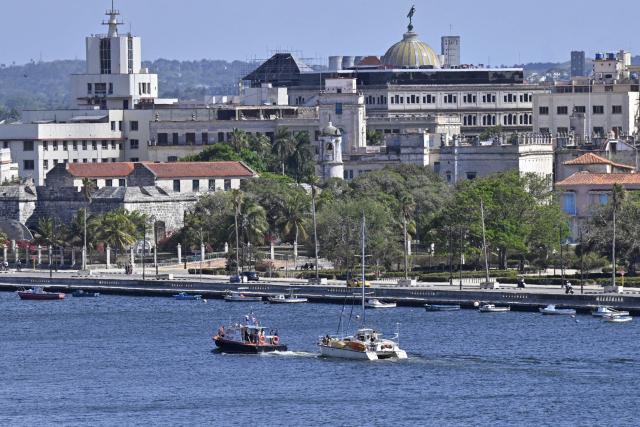 This view shows one of the two sailboats (R) carrying humanitarian aid that had previously gone missing arriving at the port of Havana on March 28, 2026. Two sailboats carrying humanitarian aid to crisis-hit Cuba reached Havana on Saturday after a long journey from Mexico during which they went missing and triggered a search-and-rescue mission, (Photo by Adalberto ROQUE / AFP)