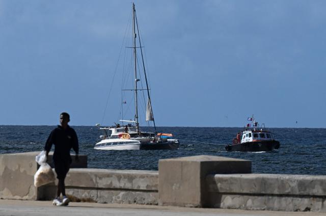 This view shows one of the two sailboats (L) carrying humanitarian aid that had previously gone missing arriving at the port of Havana on March 28, 2026. Two sailboats carrying humanitarian aid to crisis-hit Cuba reached Havana on Saturday after a long journey from Mexico during which they went missing and triggered a search-and-rescue mission, (Photo by Yamil LAGE / AFP)