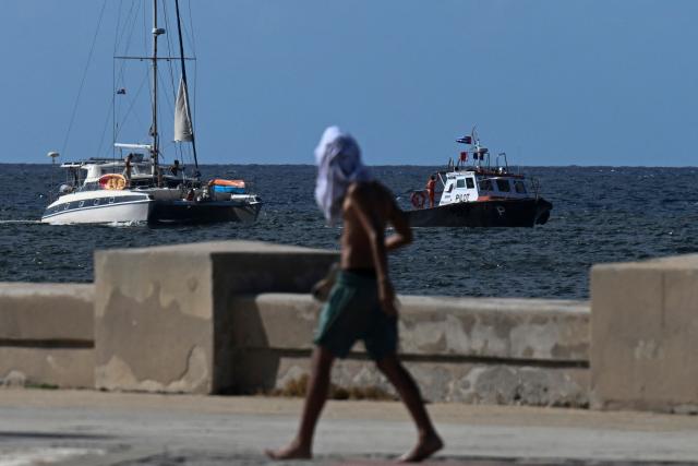 This view shows one of the two sailboats (L) carrying humanitarian aid that had previously gone missing arriving at the port of Havana on March 28, 2026. Two sailboats carrying humanitarian aid to crisis-hit Cuba reached Havana on Saturday after a long journey from Mexico during which they went missing and triggered a search-and-rescue mission, (Photo by Yamil LAGE / AFP)