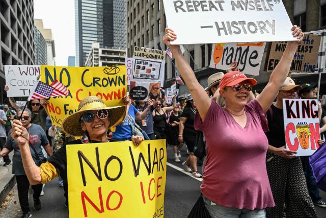 People holding signs march downtown during the "No Kings" national day of protest in Houston on March 28, 2026. Nationwide protests against US President Donald Trump are expected Saturday as millions of people vent fury over what they see as his authoritarian bent and other forms of cruel, law-trampling governance. It is the third time in less than a year that Americans will take to the streets as part of a grassroots movement called "No Kings," the most vocal and visual conduit for opposition to Trump since he began his second term in January 2025. (Photo by RONALDO SCHEMIDT / AFP)