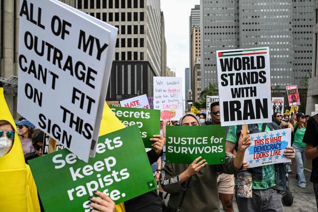 People holding signs march downtown during the "No Kings" national day of protest in Houston on March 28, 2026. Nationwide protests against US President Donald Trump are expected Saturday as millions of people vent fury over what they see as his authoritarian bent and other forms of cruel, law-trampling governance. It is the third time in less than a year that Americans will take to the streets as part of a grassroots movement called "No Kings," the most vocal and visual conduit for opposition to Trump since he began his second term in January 2025. (Photo by RONALDO SCHEMIDT / AFP)