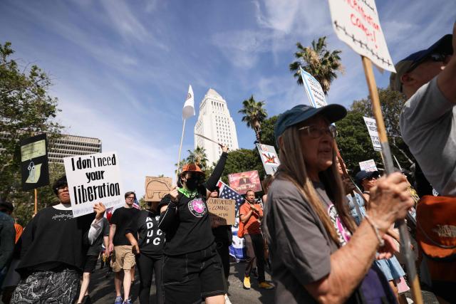 Protestors holding signs begin their march from Los Angeles City Hall during the "No Kings" national day of protest in Los Angeles on March 28, 2026. Nationwide protests against US President Donald Trump are expected Saturday as millions of people vent fury over what they see as his authoritarian bent and other forms of cruel, law-trampling governance. It is the third time in less than a year that Americans will take to the streets as part of a grassroots movement called "No Kings," the most vocal and visual conduit for opposition to Trump since he began his second term in January 2025. (Photo by Etienne Laurent / AFP)