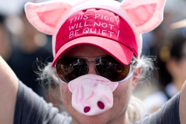 A demonstrator wears a pig nose and a red hat reading "This Piggy Will Not Be Quiet" during the "No Kings" national rally in Denver, Colorado, on March 28, 2026. Nationwide protests against US President Donald Trump are expected Saturday as millions of people vent fury over what they see as his authoritarian bent and other forms of cruel, law-trampling governance. It is the third time in less than a year that Americans will take to the streets as part of a grassroots movement called "No Kings," the most vocal and visual conduit for opposition to Trump since he began his second term in January 2025. (Photo by Jason Connolly / AFP)