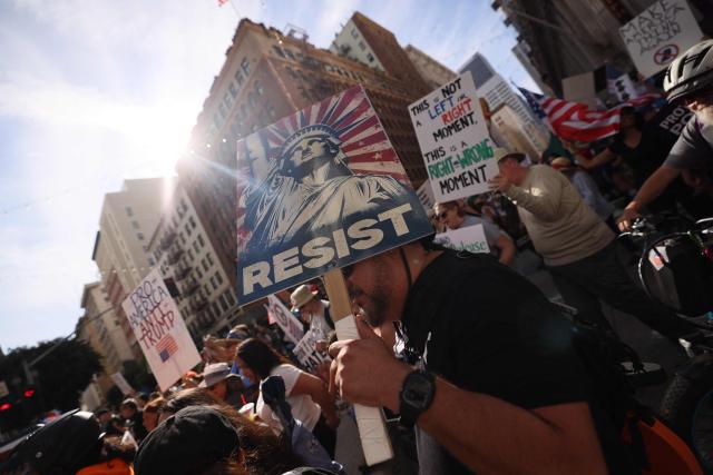 Protestors holding signs march from City Hall during the "No Kings" national day of protest in Los Angeles on March 28, 2026. Nationwide protests against US President Donald Trump are expected Saturday as millions of people vent fury over what they see as his authoritarian bent and other forms of cruel, law-trampling governance. It is the third time in less than a year that Americans will take to the streets as part of a grassroots movement called "No Kings," the most vocal and visual conduit for opposition to Trump since he began his second term in January 2025. (Photo by Etienne Laurent / AFP)