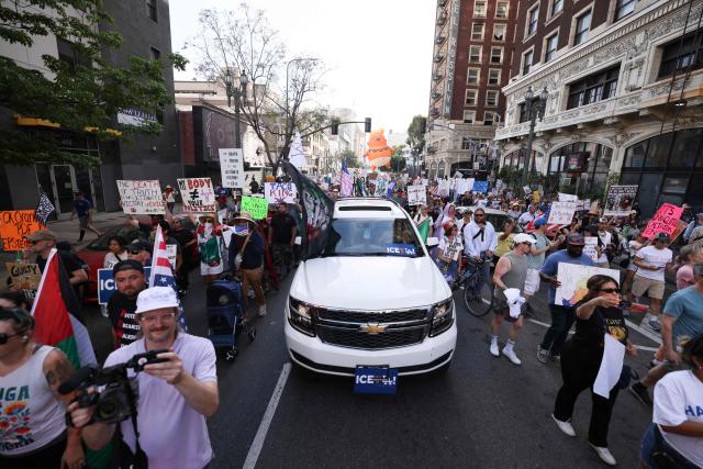 Protestors holding signs march during the "No Kings" national day of protest in downtown Los Angeles on March 28, 2026. Nationwide protests against US President Donald Trump are expected Saturday as millions of people vent fury over what they see as his authoritarian bent and other forms of cruel, law-trampling governance. It is the third time in less than a year that Americans will take to the streets as part of a grassroots movement called "No Kings," the most vocal and visual conduit for opposition to Trump since he began his second term in January 2025. (Photo by Etienne Laurent / AFP)