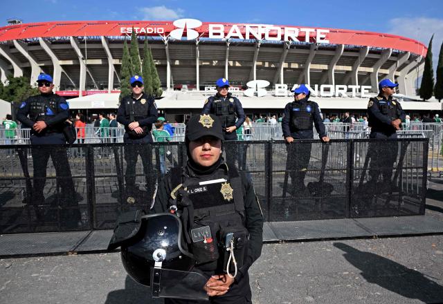 Police officers stand guard before the inauguration of Banorte Stadium (formerly known as Azteca), for a friendly match between Mexico and Portugal, in Mexico City on March 28, 2026. (Photo by Carl de Souza / AFP)