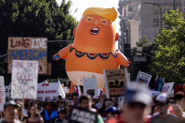 A giant inflatable balloon in the likeness of US President Donald Trump is seen as demonstrators march during the "No Kings" national day of protest in Los Angeles on March 28, 2026. Nationwide protests against US President Donald Trump are expected Saturday as millions of people vent fury over what they see as his authoritarian bent and other forms of cruel, law-trampling governance. It is the third time in less than a year that Americans will take to the streets as part of a grassroots movement called "No Kings," the most vocal and visual conduit for opposition to Trump since he began his second term in January 2025. (Photo by ETIENNE LAURENT / AFP)