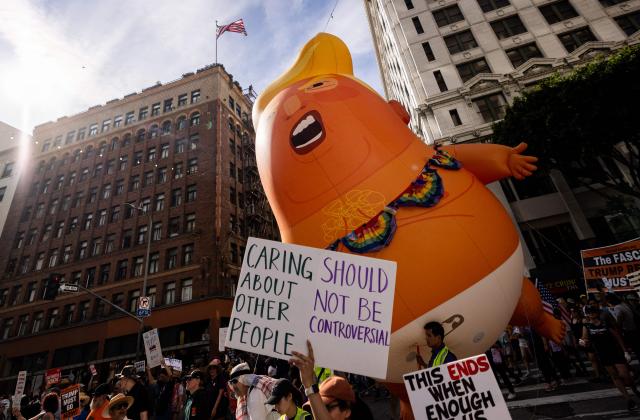 A giant inflatable balloon in the likeness of US President Donald Trump as a baby in diapers is seen as demonstrators march during the "No Kings" national day of protest in Los Angeles on March 28, 2026. Nationwide protests against US President Donald Trump are expected Saturday as millions of people vent fury over what they see as his authoritarian bent and other forms of cruel, law-trampling governance. It is the third time in less than a year that Americans will take to the streets as part of a grassroots movement called "No Kings," the most vocal and visual conduit for opposition to Trump since he began his second term in January 2025. (Photo by ETIENNE LAURENT / AFP)